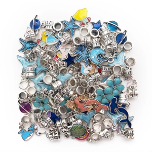 Close-up of enamel ocean and celestial themed DIY charm beads and pendants for bracelets