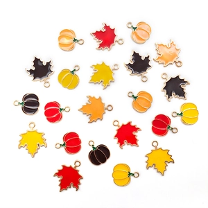 Enamel maple leaf and pumpkin charms in autumn colors for DIY jewelry and crafts