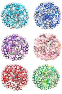 Detailed view of colorful DIY Murano glass beads and alloy charms in a circular layout