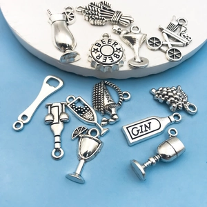 Detailed close-up of antique silver alloy wine charms and cocktail glass pendants for DIY craft