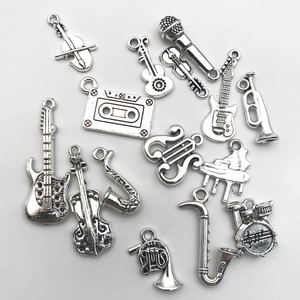 Macro shot of 13 music instrument charms in antique silver finish for DIY jewelry