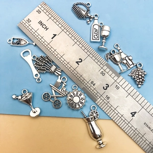 Antique silver wine theme pendants including gin bottle and grape basket charms