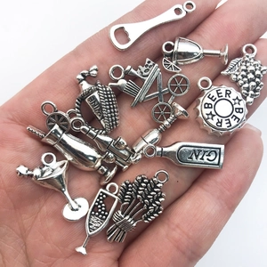 Detailed macro shot of vintage silver wine-themed charms including bottles and glasses