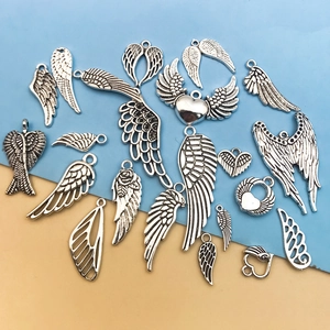 Detailed view of assorted silver heart and angel wing charms for DIY jewelry making