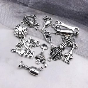 Detailed view of silver antique alloy wine glass and bottle pendants for DIY jewelry