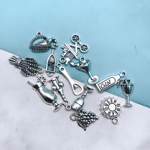 Macro detail of antique silver alloy wine charms and cocktail pendants for DIY jewelry