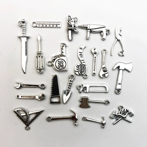 Macro shot of 20 vintage silver zinc alloy mini tool charms for DIY jewelry making