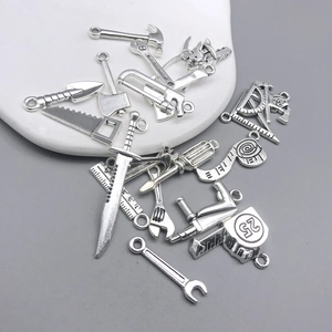 Detailed view of assorted silver zinc alloy mini tool charms for DIY jewelry making