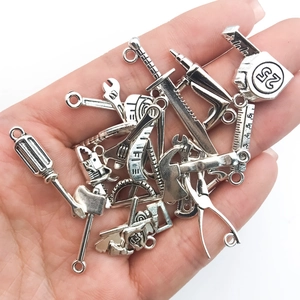 Macro shot of 20 zinc alloy mini hardware tool pendants for DIY jewelry making