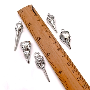 Gothic vintage silver bird skull pendants in various styles with measurement ruler
