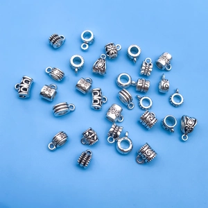 Detailed close-up of antique silver alloy connectors and beads for DIY jewelry making