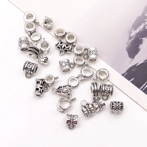 Detailed macro view of antique silver alloy spacer beads with intricate floral engravings