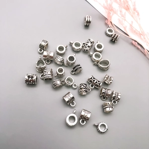 Close-up of vintage silver alloy connectors with floral and heart patterns for DIY jewelry