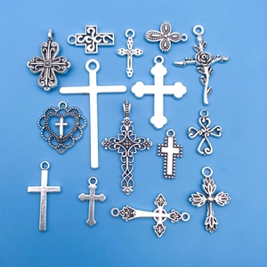 Set of 15 unique silver-tone cross pendants for DIY necklaces and crafts on blue background
