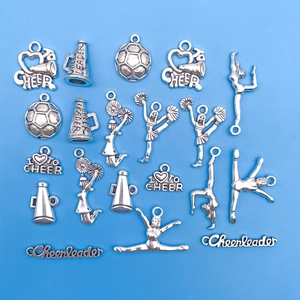 Detailed view of silver antique cheerleading charms and megaphones on blue background