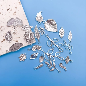 Detail of silver alloy leaf pendants including ginkgo and maple designs for DIY jewelry
