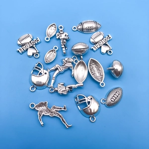 Macro shot of silver rugby-themed pendants including helmets and I Love Football charms