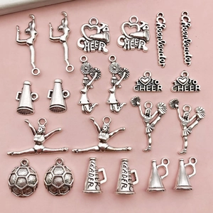 Macro detail of silver cheerleader charms with football and megaphone shapes