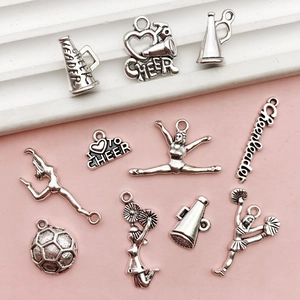 Macro shot of 10 assorted antique silver cheerleader pendants for DIY jewelry making