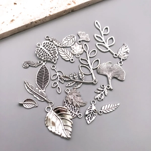 Detailed view of antique silver leaf alloy charms for DIY bracelet and jewelry making