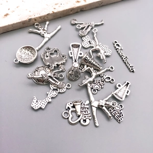 Detailed macro view of silver cheerleader charms with megaphone and cheerleader motifs