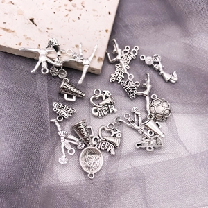 Macro shot of antique silver cheerleader charms for DIY jewelry making accessories