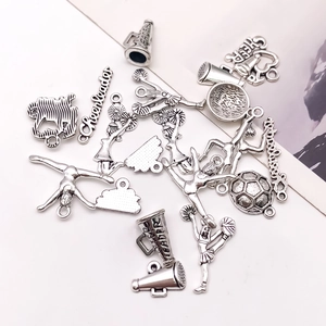 Detail of vintage silver cheerleader charms with megaphones and sport pendants