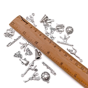 Antique silver cheerleader charms set with various sports shapes and a measurement ruler