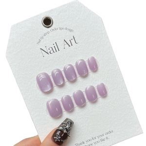 Handmade light purple shimmering press-on nails set on a white textured display card