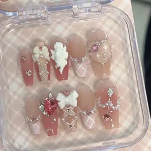 Pink gradient balletcore press-on nails with 3D bows, angels, and heart rhinestones