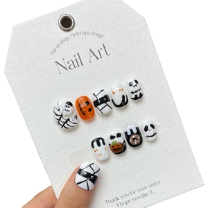 Handmade Halloween press-on nails featuring cute hand-painted pumpkins and ghosts