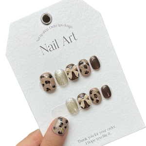 Handmade brown leopard print press-on nails with 3D bows and silver wire drawing effect