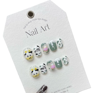 Handmade cow pattern press-on nails set with cute milk bottle art and green polish finish