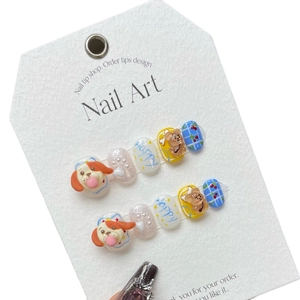 Handmade 3D press-on nail set featuring blue plaid designs and cute puppy charms on white background