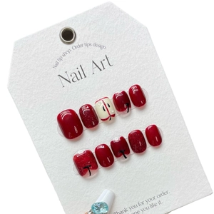 Faux ongles faits main bordeaux avec paillettes et design minimaliste de pomme d'art