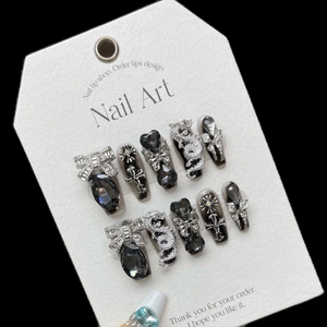 Handmade gothic press-on nails in black cat eye with silver dragon and bow charms