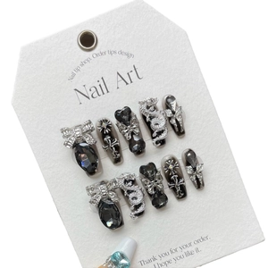 Dark luxury handmade press-on nails with silver dragon and cross charms on black base