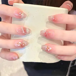 Cat eye press-on nails with nude pink gradient, pearls, and shell foil details