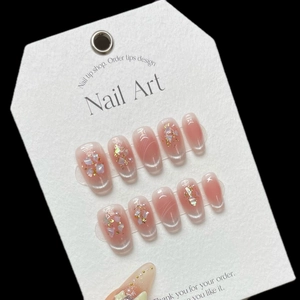 Pink gradient cat-eye press-on nails with shell fragments and gold foil accents