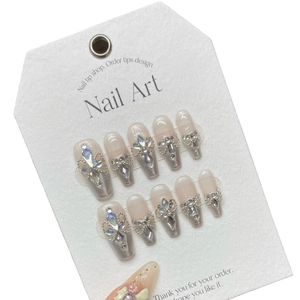 Handmade aurora press-on nails with silver cat-eye finish, rhinestones, and 3D bows