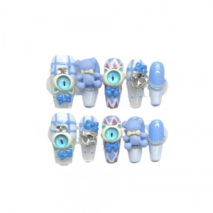 Handmade press-on nails with 3D blue bear and cat eye charms on light blue base