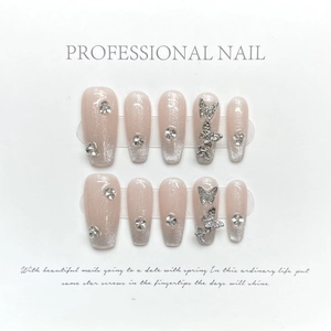 Handmade nude pink cat-eye press-on nails with silver glitter gradient and 3D butterflies