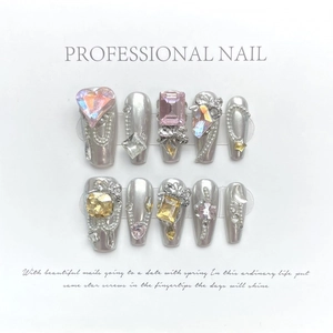 Silver mirror press-on nails with pink heart rhinestones and metallic Y2K charms