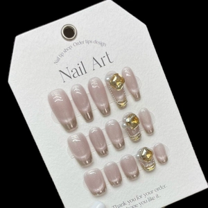 Handmade press-on nails set in nude cat-eye style with French tips and 3D rhinestones