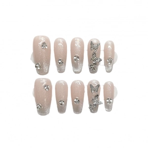Nude pink to silver glitter press-on nails with 3D metal butterfly and rhinestone accents