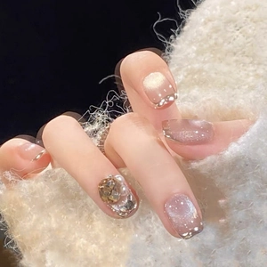 Nude cat-eye press-on nails with amber crystal and pearl luxury design for women