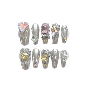Silver metallic press-on nails with 3D pink hearts, pearls, and butterfly charms