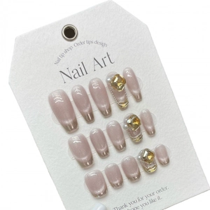 Handmade cat-eye press-on nails in nude purple with French gold tips and crystals
