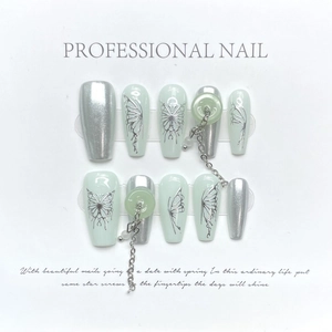 Handmade mint green press-on nails with silver butterfly and pendant charms