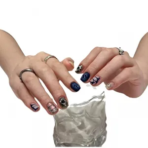 Handmade press-on nails with dark blue star patterns and silver metallic mirror finish